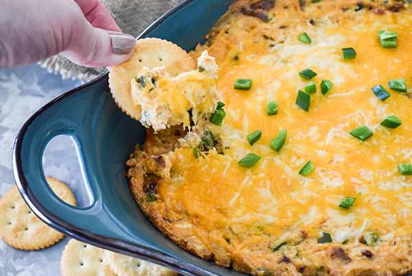 jalapeno popper dip being scooped up on cracker