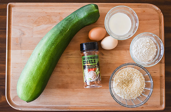 ingredients for baked zucchini fries, zucchini, panko crumbs, eggs, milk, flour, and chugwater chili dip & dressing mix