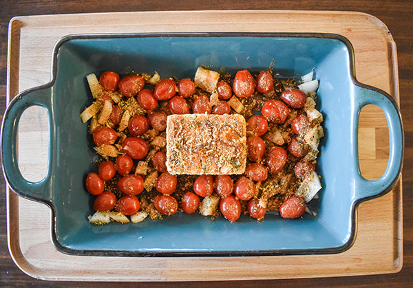 feta, tomatoes, onion, chugwater chili dip mix, olive oil, and oregano added to a baking dish