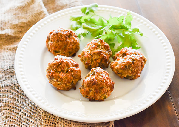 cheesy green chile sausage balls on plate ready to eat