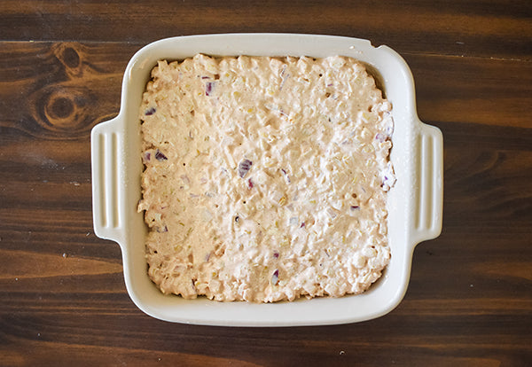 street corn dip added to a baking dish before being baked at 375 for 40 minutes