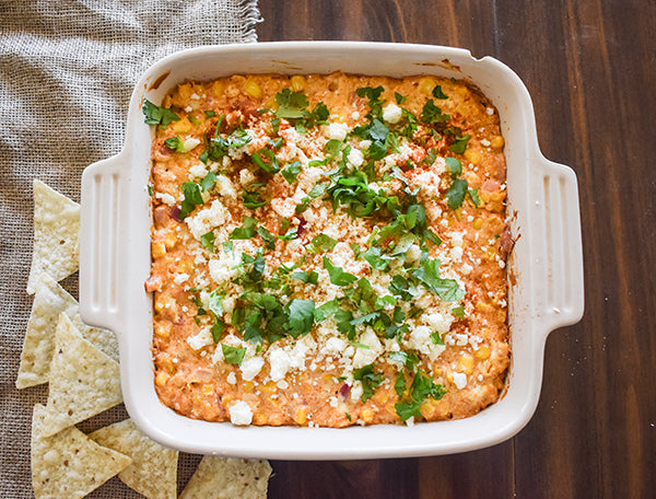 cotija cheese, cilantro, and chili seasoning added to the top of the street corn dip