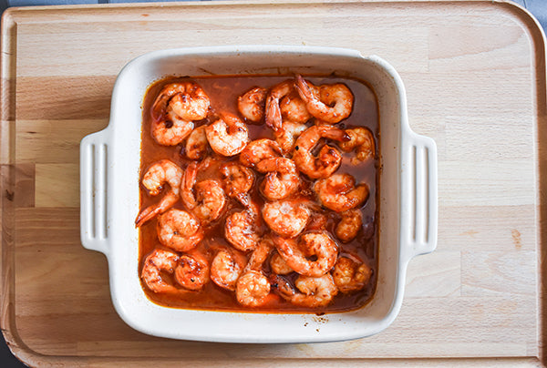 Red Pepper Jelly glaze on seasoned shrimp in pan