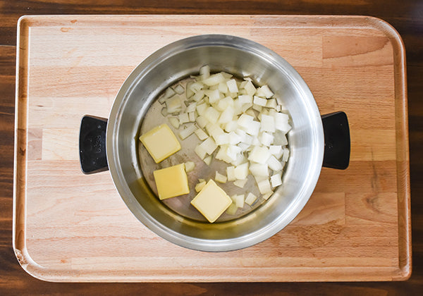 1/2 diced onion in medium pot with butter ready to saute