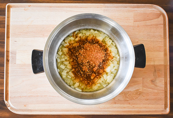 Chugwater Chili Dip & Dressing Mix added to pot with sautéed onion 