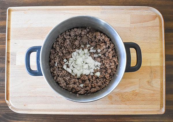 Ground beef in pot browned with onion