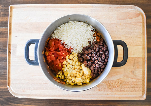 rice, corn,, beans, and diced tomatoes with green chilies added to browned meat