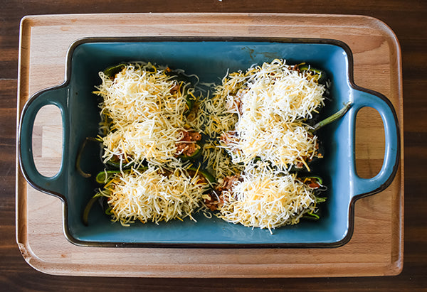 shredded cheese added to top of stuffed poblano peppers