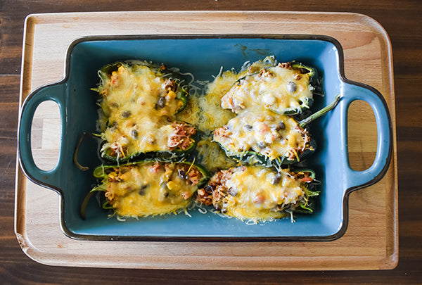 cheese melted on top of stuffed poblano peppers
