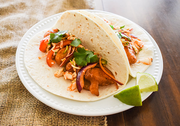 crispy fish tacos with chili lime coleslaw on plate 