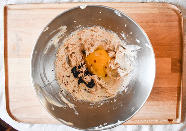 egg and vanilla added to brown sugar and butter mixture in mixing bowl