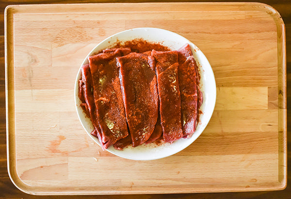 2 inch sliced steak strips seasoned with chugwater chili seasoning and oil