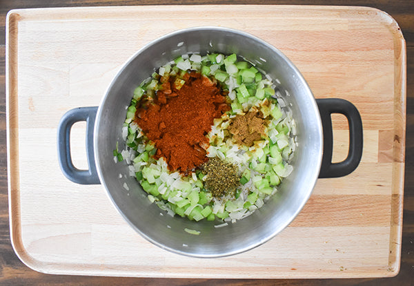 Chugwater Chili Seasonine, oregano, and cumin added to sauteed garlic, jalapeno, onion in pot