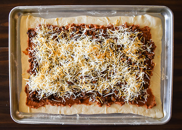 shredded fiesta blend cheese added on top of the taco pizza