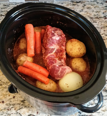 up close photo of roast and veggies in slow cooker