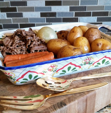 up close photo of pot roast meal in serving dish