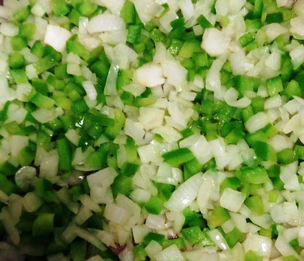 close up photo of diced green peppers and onions