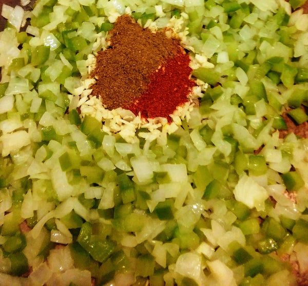 photo of the spices in the pot with the softened vegetables