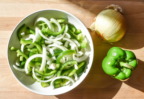 Photo of chopped onion and bell peppers in bowl