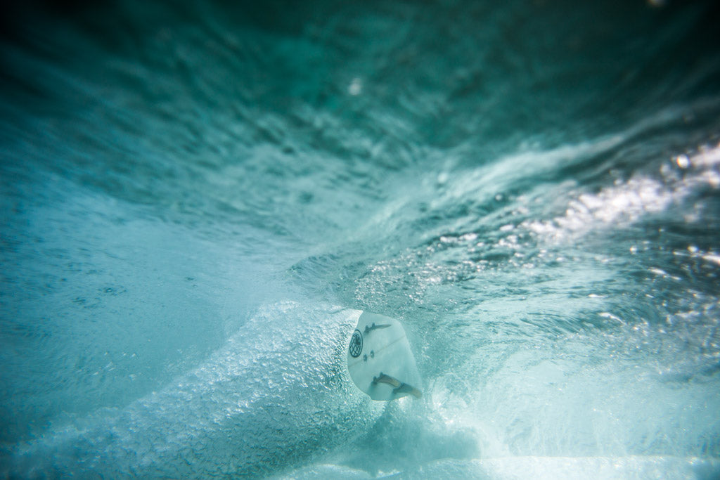 Surfboard from beneath the wave 