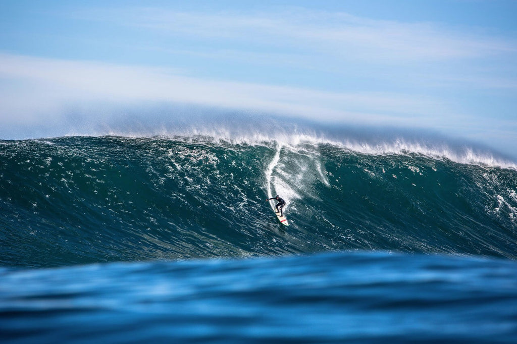 Mike surfing a massive wave at Dungeons