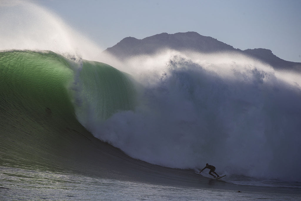 Mike surfing a massive wave in Kommetjie 