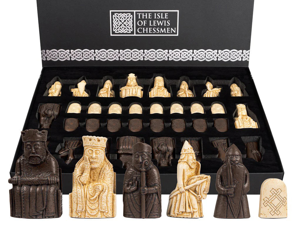 Isle of Lewis chess set featuring intricately carved ivory and dark pieces in display box