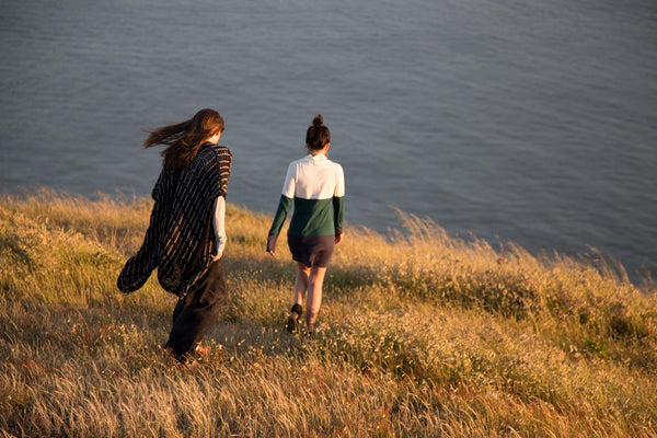 Celebrate earth day by making the fashion industry greener - 2 girls walking in a file wearing sustainable fashion