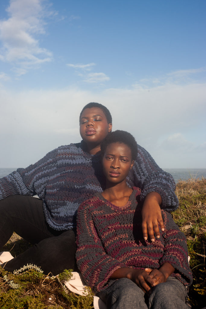 models wearing the hand knit maleng sweater made using upcycled textile scraps