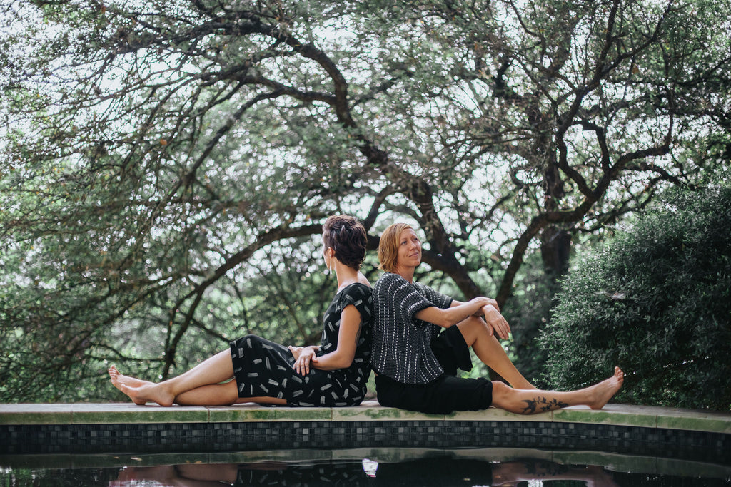 Kim and Jess wearing sustainable outfits from tonlé by the pool in Austin, TX.