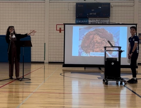 Mad Gab's Founder, Gabrielle Melchionda smiling and excited to present her story to a full house of local middle schoolers.