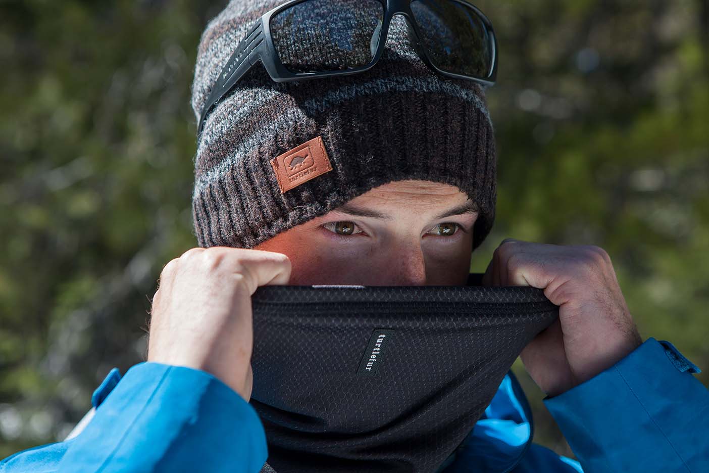 Close up of man pulling neck gaiter over face