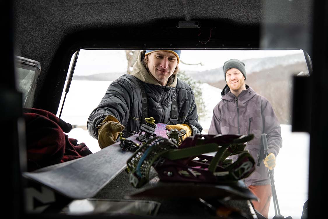 Man packing skis into truck