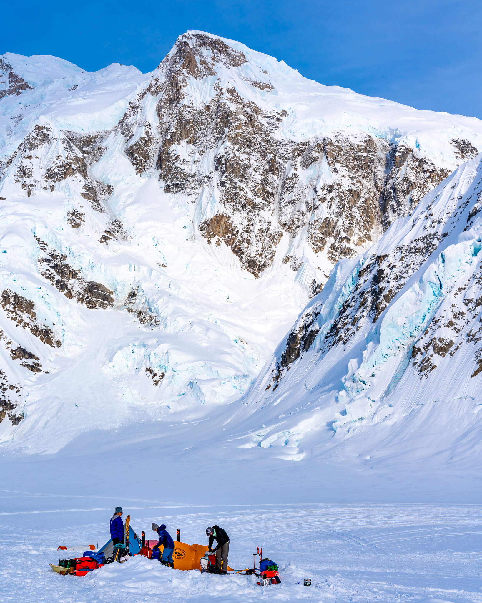 The team unpacks and digs in at Kahiltna Base Camp, Mount Hunter in the background