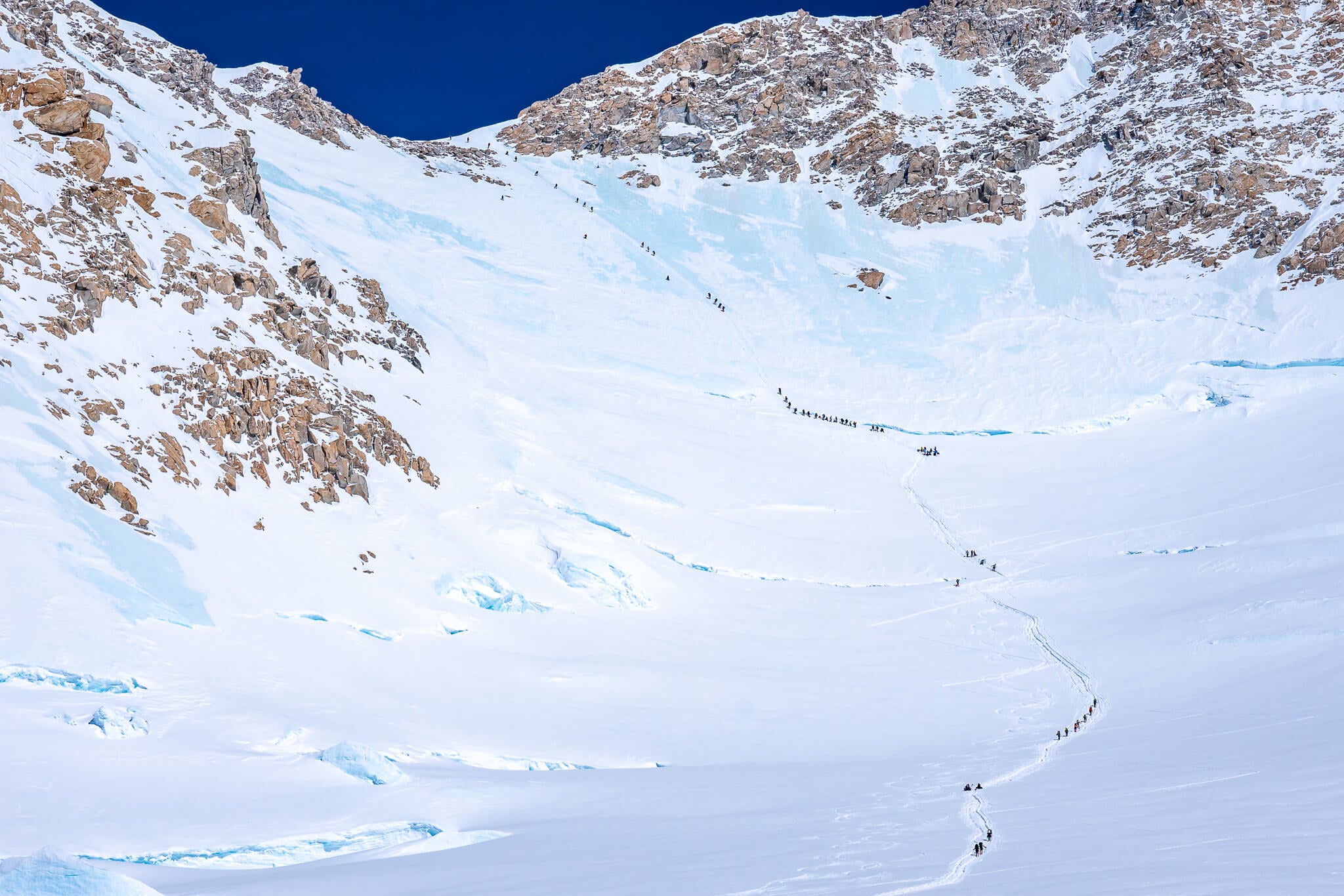 Dozens of climbers ascend from the campsite at 14,200 feet on Denali