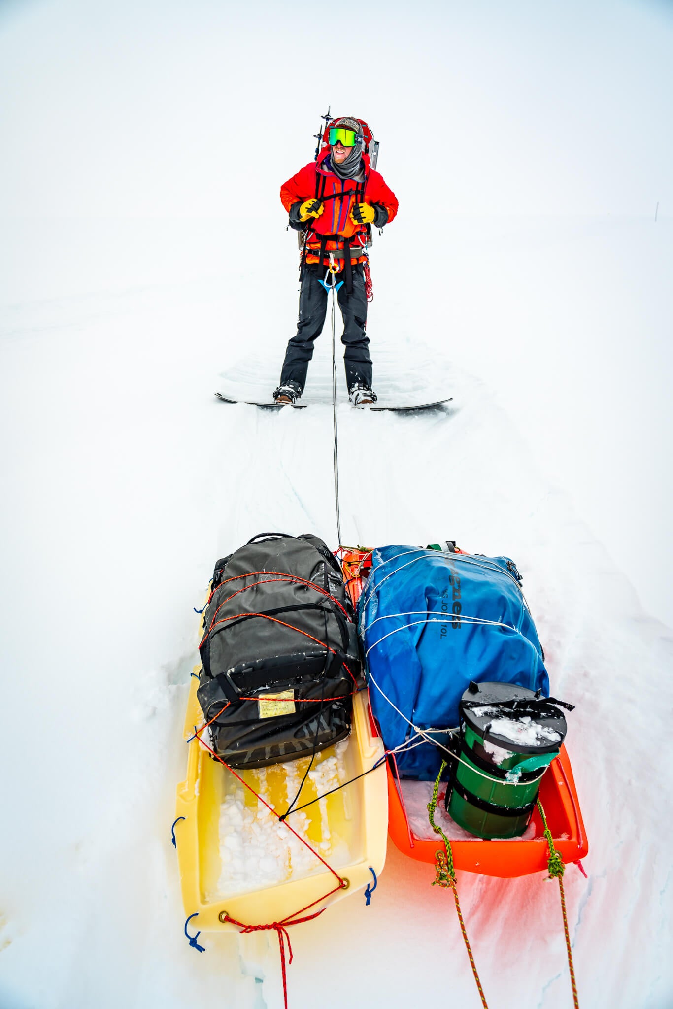 Joey Sackett wrangles 2 of our sleds on the descent from Denali