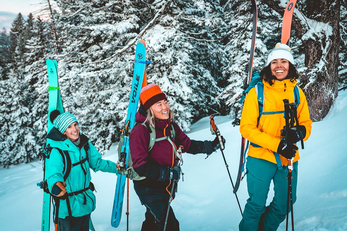 three friends skinning up snow covered mountain