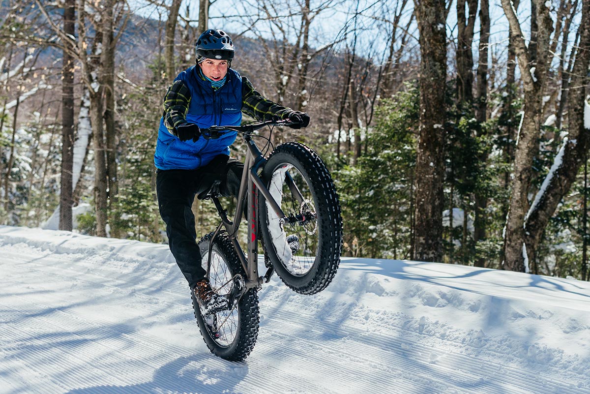 picture of a man popping a wheelie on a fat bike