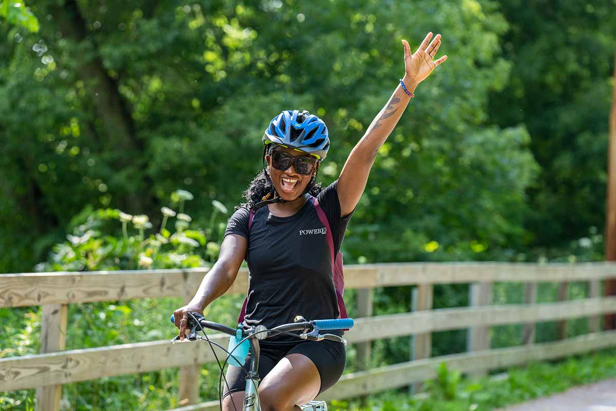 woman smiling while riding bike
