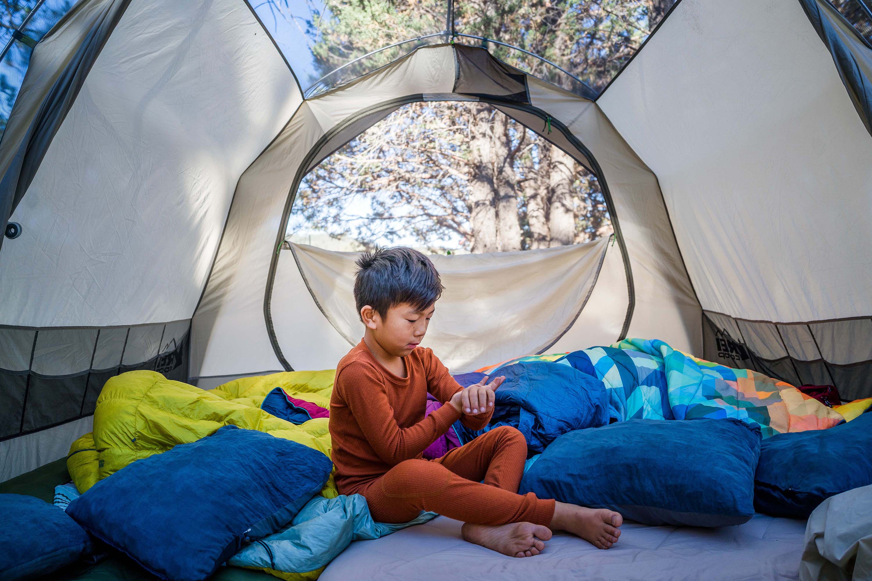 Boy sitting in camping tent