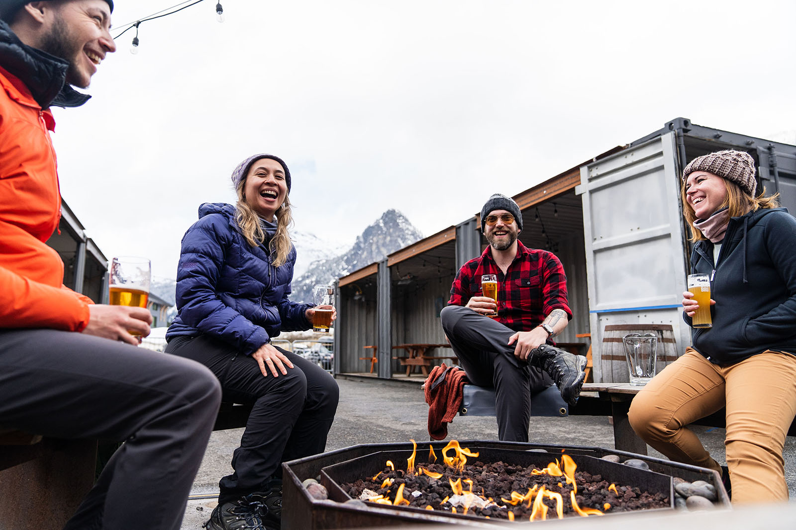 photo of friends laughing around a fire