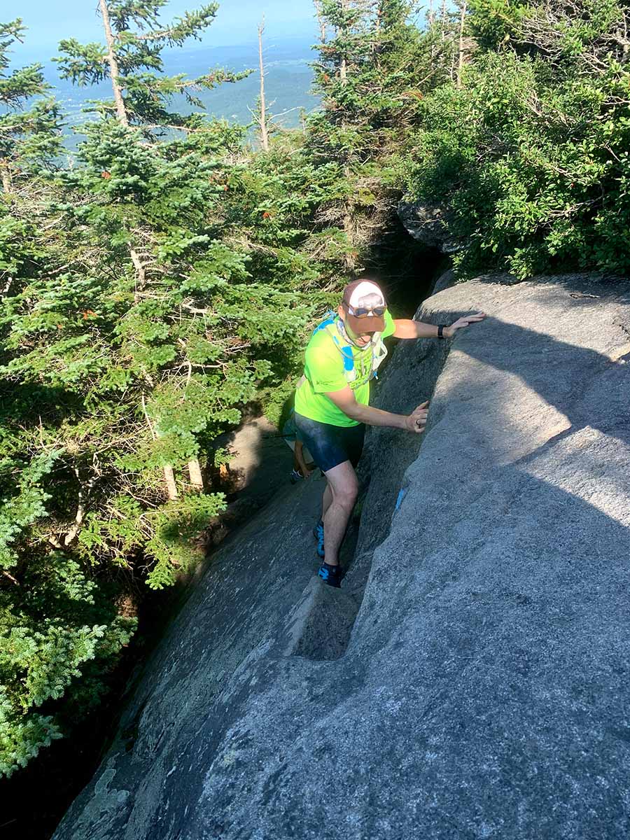 Man climbing rock on Frost, Butler Trail Loop