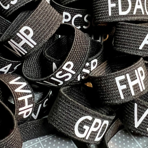 Badgeart Custom Printed mourning bands with a variety of agency initials offered by badgeart custom mourning bands for police officers, firefighters and others.