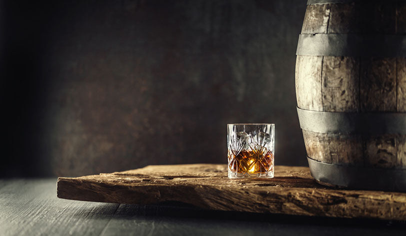 glass bourbon on wood table