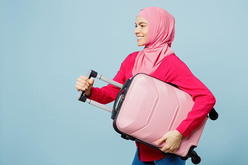 woman in pink outfit with pink suitcase