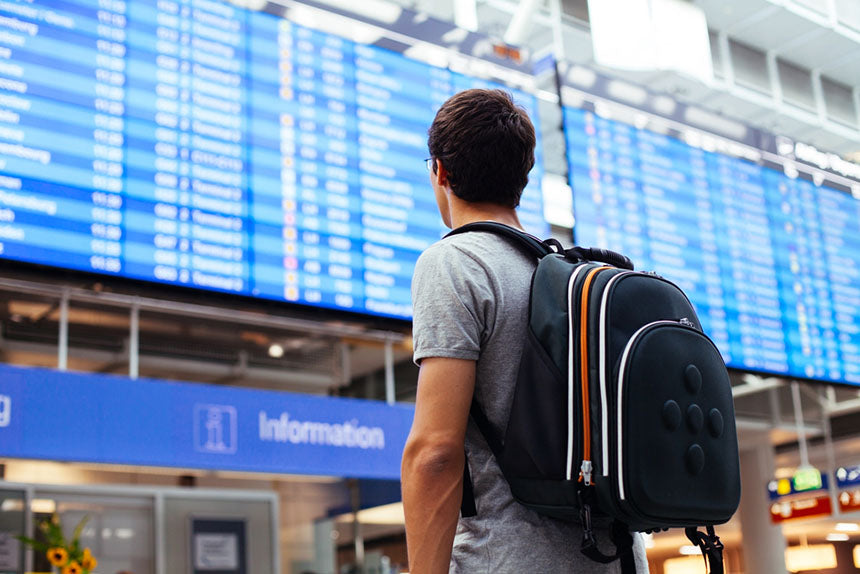 young man with backpack in airport