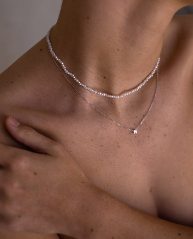 close up of necklaces around woman's neck