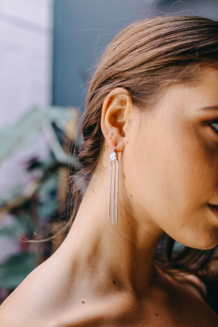 Styled image of our Constellations earrings  on the ear of a brunette woman.
