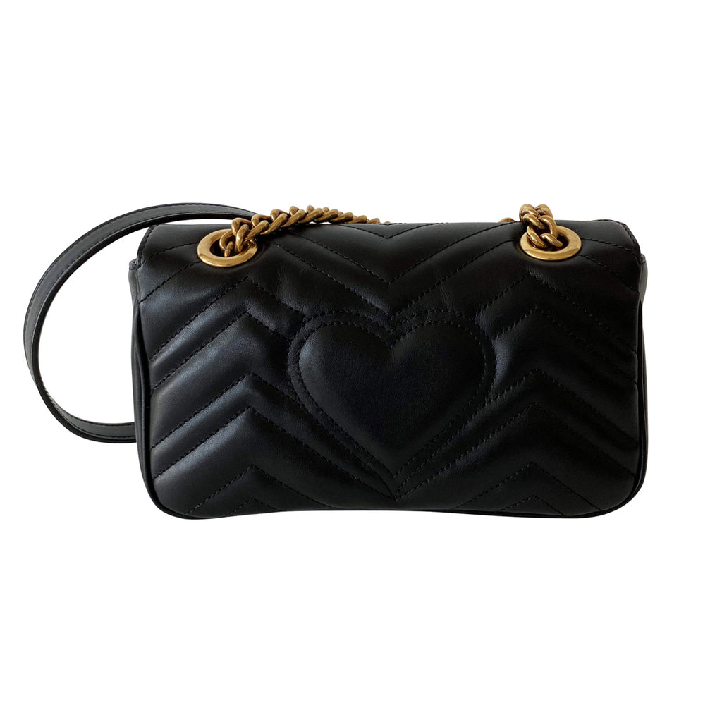 black gucci bag with heart on back