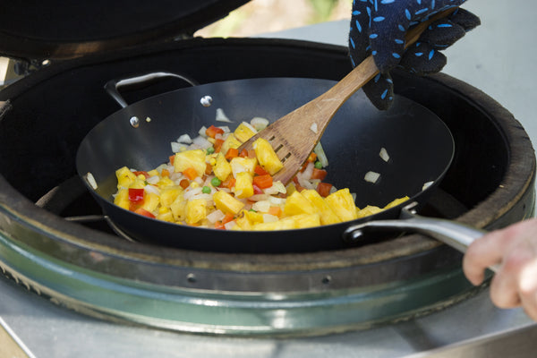 starting to cook the fried rice ingredients over Fogo Lump Charcoal